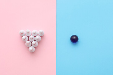 Miniature bowling, pins with ball on pink blue background