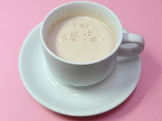 Malaysian Teh Tarik or Hot Milky Drink Served in a Traditional Cup. Mug of Frothy Hot Drink with Subtle Foam Texture