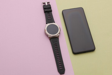 Modern gadgets. Smartphone and Smart watch on pastel background