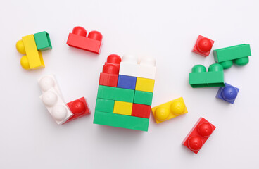 Colored plastic toy bricks on white background