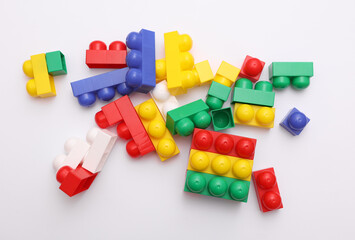 Colored plastic toy bricks on white background