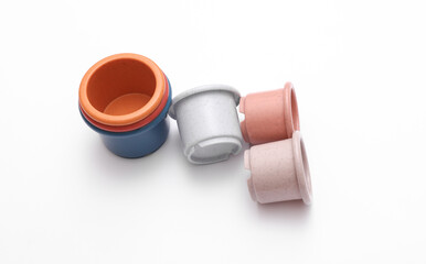 Colored toy bowls pyramid on white background
