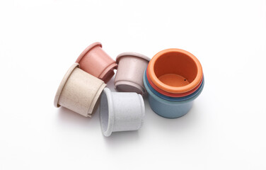 Colored toy bowls pyramid on white background