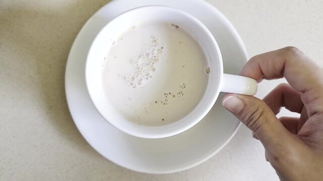 Malaysian Teh Tarik or Hot Milky Drink Served in a Traditional Cup. Mug of Frothy Hot Drink with Subtle Foam Texture