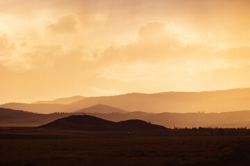 Golden sunset over Altai mountains, beautiful mystical landscape in Altay, Russia