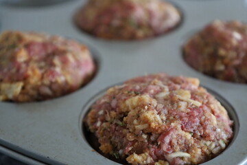 Close-up of raw meatloaf muffin in pan