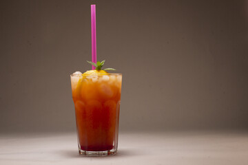 Alcoholic or non alcoholic cocktail in a stylish glass on a gray background, photographed in studio conditions as part of food and beverage product shooting.
