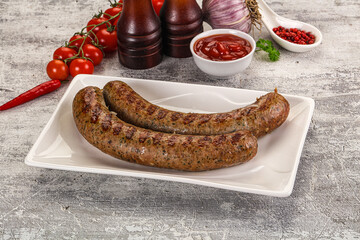 Grilled beef sausages with sauce