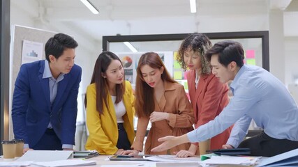 Asian business creative agency team brainstorms and shares innovative ideas together in a modern office interior, preparing presentation strategy with agile thinking and resilient teamwork to drive - Powered by Adobe