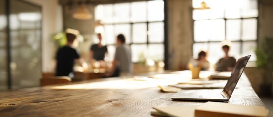 The laptop on a collaborative workspace in a modern office setting.