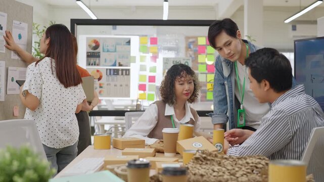 Creative business  product developers actively brainstorm ideas, sharing discussions ESG  green energy focusing on product repackaging and reuse strategies to reduce costs maximize profit business