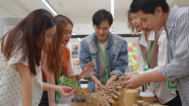 Creative business  product developers actively brainstorm ideas, sharing discussions ESG  green energy focusing on product repackaging and reuse strategies to reduce costs maximize profit business