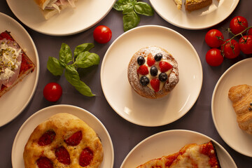 A vibrant array of delightful food beautifully arranged, featuring fresh cherry tomatoes and basil leaves