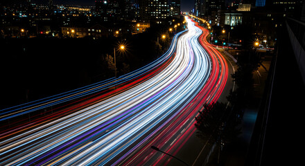 City Lights: Long Exposure Captures the Vibrant Trails of Cars at Night, A dazzling display of urban movement as vehicles paint the night with streaks of light
