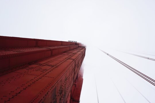 looking up at the Golden Gate Bridge on a foggy day