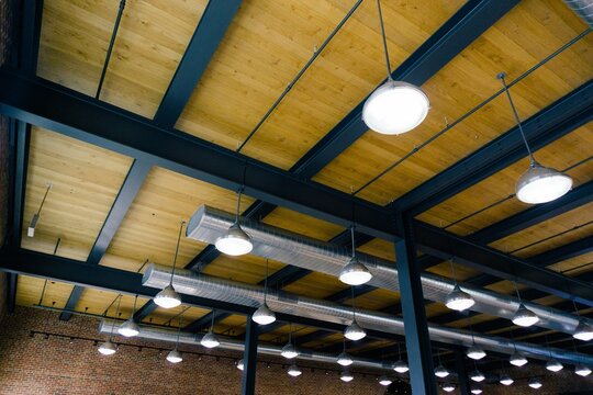 Round ceiling lights inside office building with industrial look and feel