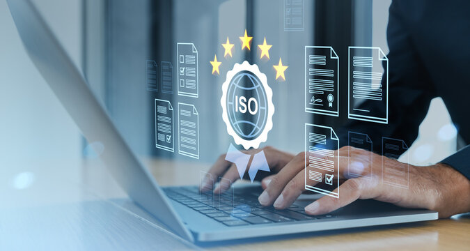 ISO certification and quality standart concept with digital documents and rating stars on transparent interface over laptop screen in office background.