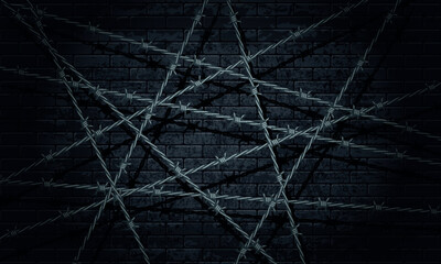Barbed wire and brick wall. Black brick wall with barbed wire.