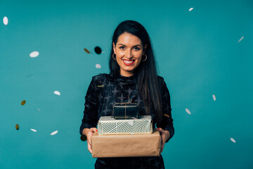 Happy woman holding christmas gifts celebrating holiday