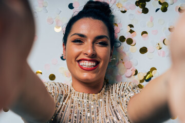 Smiling woman celebrating new year taking selfie