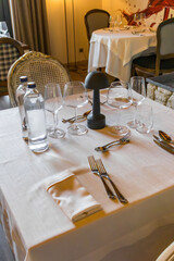 Urla, Turkey 14 August 2025:Stylish restaurant table setting with glasses, cutlery, and white napkins. Perfect for hospitality, fine dining, and lifestyle themes.