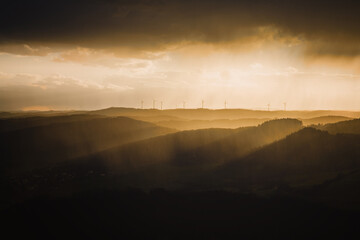 Storm over the hills with rain, hail and some sunlight. Taken from a viewing point called Rimberg, near Marburg, Germany.