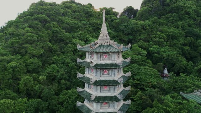 Aerial Close-up of Xa Loi Pagoda Tower Amidst Jungle Foliage, Marble Mountains, Da Nang