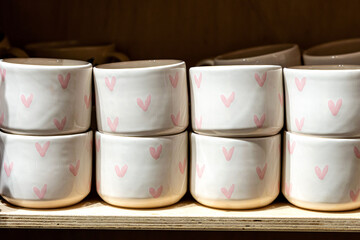 Cute ceramic cups with pink heart pattern