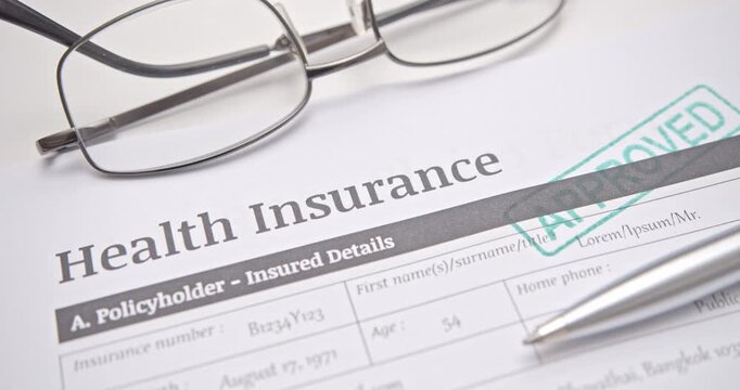 Health insurance document with APPROVED stamp, symbolizing successful medical claim, healthcare policy approval, and financial protection.