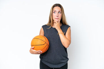 Young basketball caucasian player woman isolated on white background having doubts and thinking