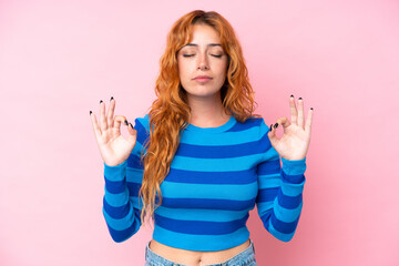 Young caucasian woman isolated on pink background in zen pose