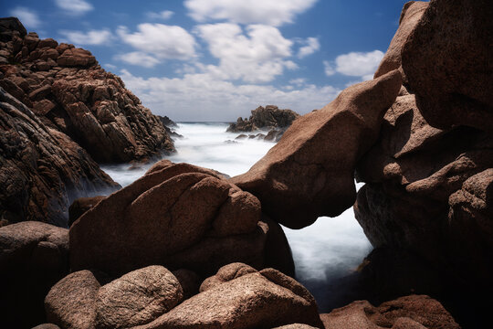 Tafoni rocks at the coast of Tizzano, Corse, France. Long exposure with some motion in the water of the Mediterranean Sea.