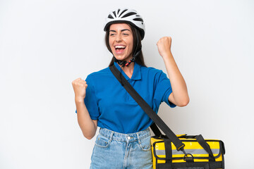 Young caucasian woman with thermal backpack isolated on white background celebrating a victory