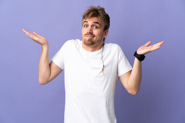 Fototapeta premium Young handsome blonde man isolated on purple background making doubts gesture
