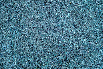 Closeup of blue rubber safety surface used on playgrounds. Soft, shock-absorbing material for safe outdoor play areas
