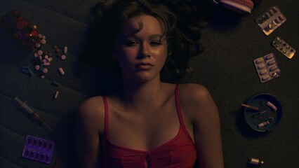 Vicious woman with drugs, cigarettes and pills