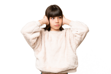 Little girl over isolated green chroma key background frustrated and covering ears