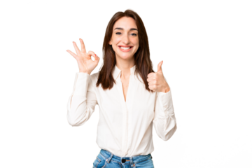 Young caucasian woman over isolated chroma key background showing ok sign and thumb up gesture