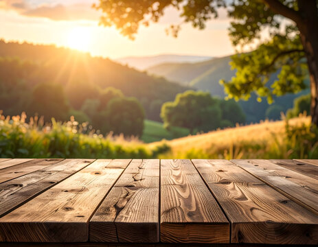 Rustic wooden table in natural light, overlooking a stunning sunset landscape with rolling hills and vibrant golden hour glow, ideal for product presentations