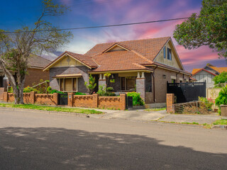 Obraz premium Beautiful colours of a Spring Sunset over Residential houses in inner Sydney suburb of Ashbury NSW Australia Double Brick federation house western sydney 