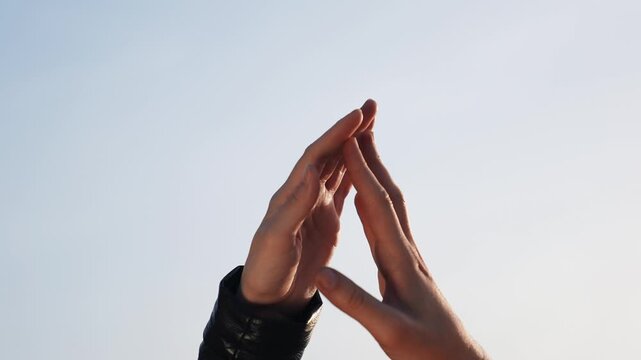 High five between hands showing connection and cooperation two pairs of hands meeting with gentle touch and gesture conveying friendship teamwork celebration unity and partnership across skin