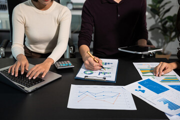 Businessmen team or financial data analysts working with tablets and laptop computers and data graphs together. Plan to analyzing projects in the office.