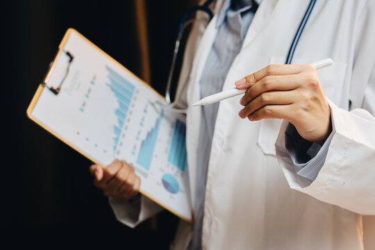 Medical Professional Analyzing Health Data with Charts and Statistics in a Clinical Environment
