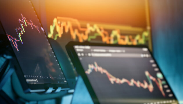 Multiple trading screens showing market analysis