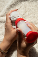 Tiny kitten drinking milk from bottle in caregiver's hands