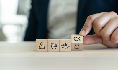 Customer Experience Strategy Concept. Wooden blocks with various stage icons of customer experience, including shopping, feedback and satisfaction. Marketing strategies and personalized engagement.