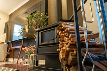 Neatly Stacked Firewood in Indoor Log Storage Rack beside Fireplace