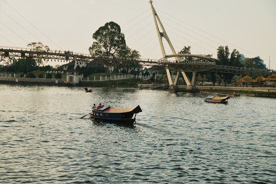 Darul Hana Bridge in Kuching, Sarawak, Malaysia, seen from the waterfront with traditional boats operating on the Kuching River, located on the island of Borneo, Malaysia.