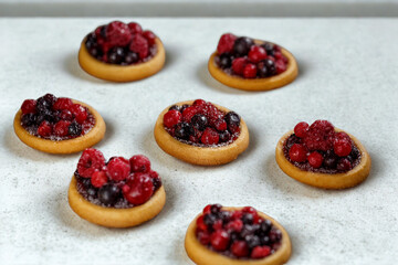 Mini tartlets filled with fresh pomegranate and berries