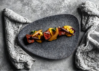 Gourmet roasted vegetable medley on a dark textured plate